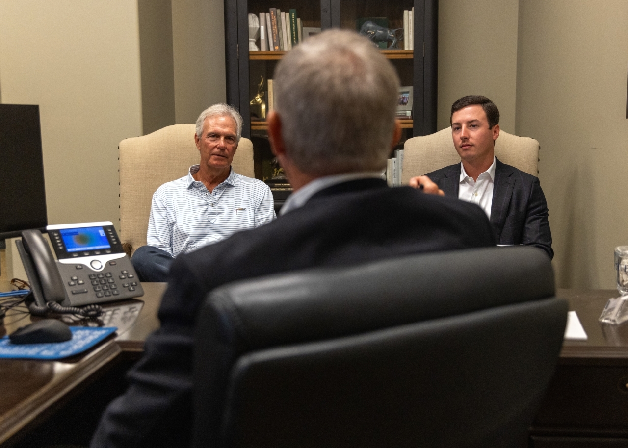 Sonny and Luke Skinner speaking with senior client in Sonny's office